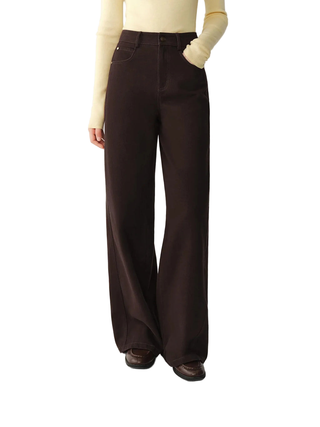 A model wearing dark brown wide-leg trousers, a cream long-sleeve top, and brown shoes, shown from the waist down against a light gray studio background. The brand logo 'fsle' is visible in the top-left corner.