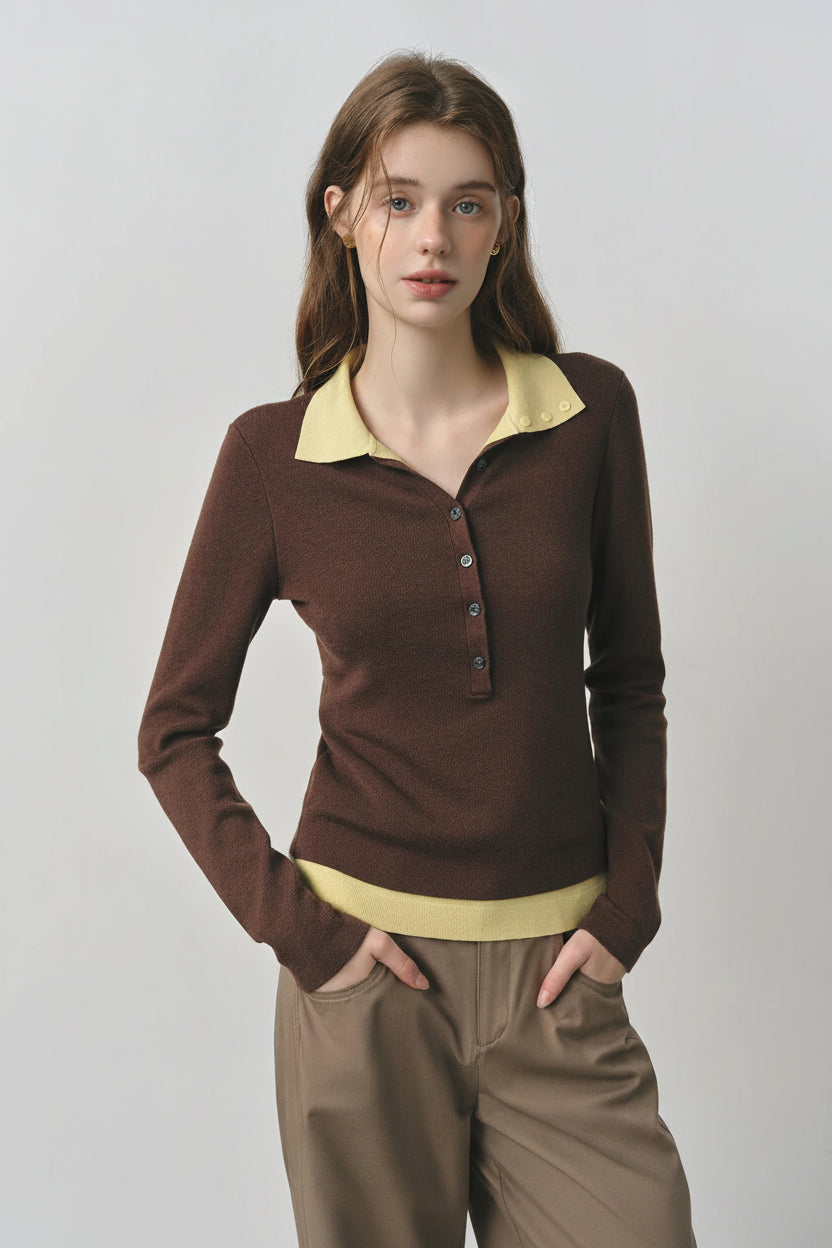 Woman wearing a brown and yellow long-sleeve top with a plain background