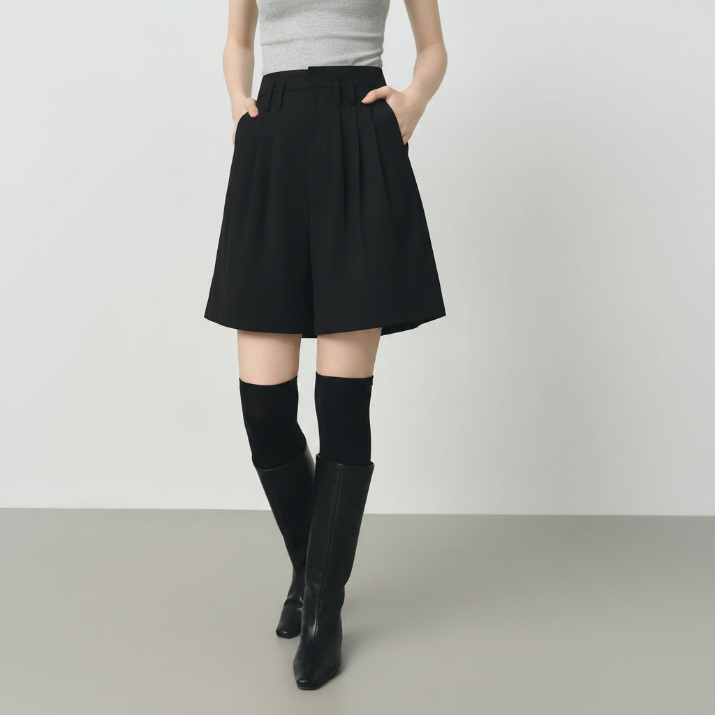 Person wearing a black skirt with a plain background
