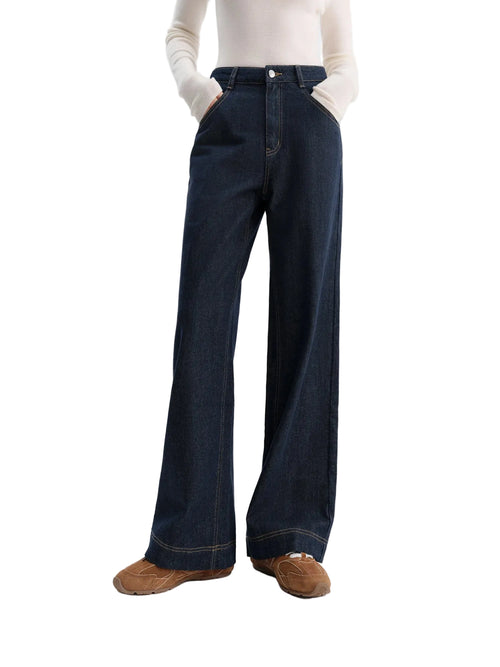 Person wearing dark blue wide-leg jeans on a white background with 'fsle' branding.